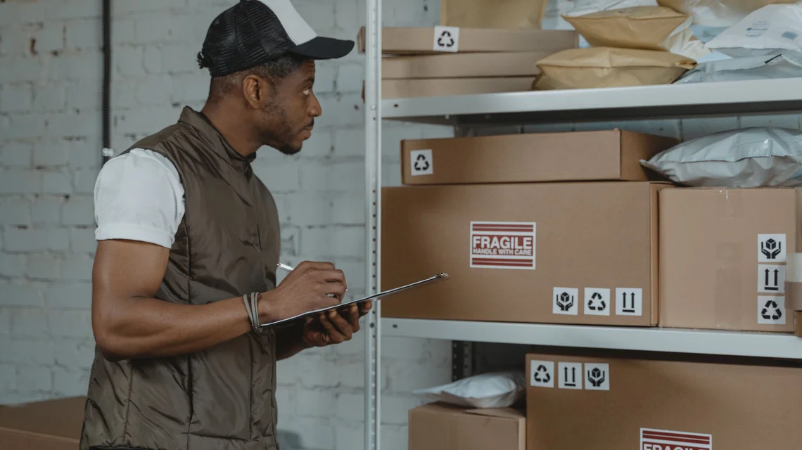 Packages moving along a conveyor in a fulfilment warehouse