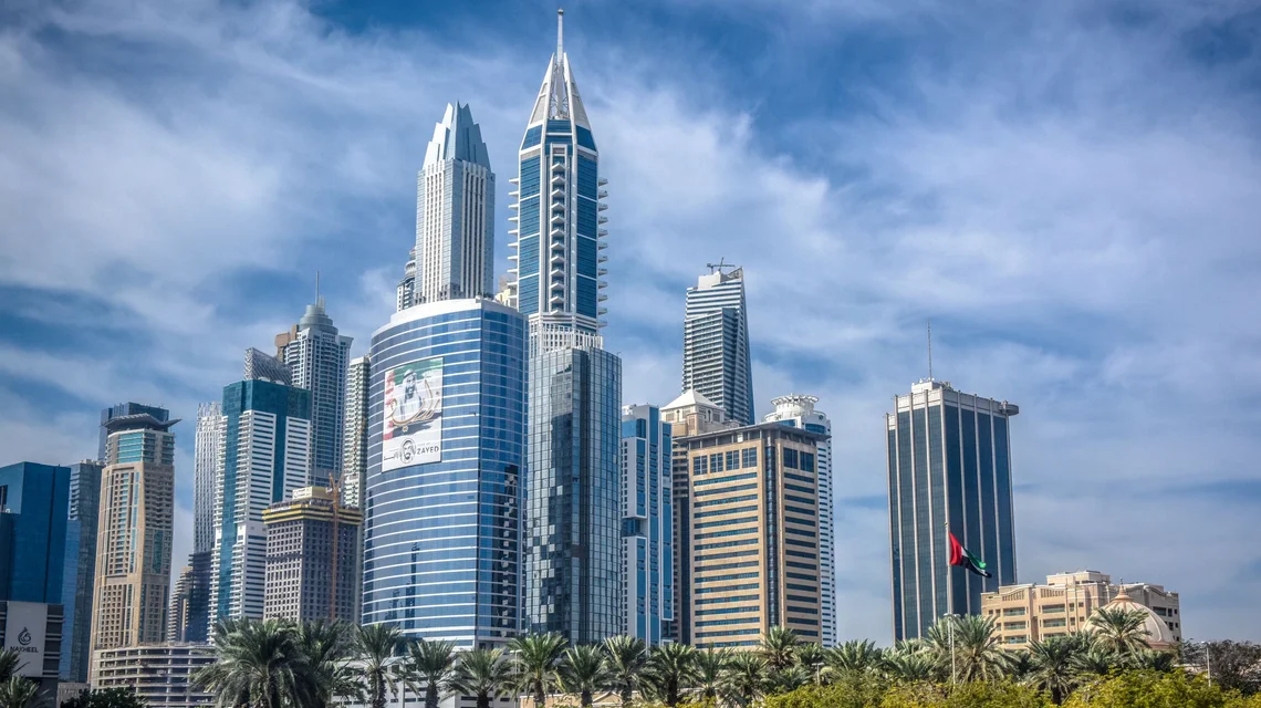 DIFC Gate building and financial district towers at dusk in Dubai