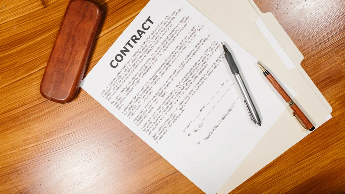 A courier envelope of documents being handed over at an office reception counter
