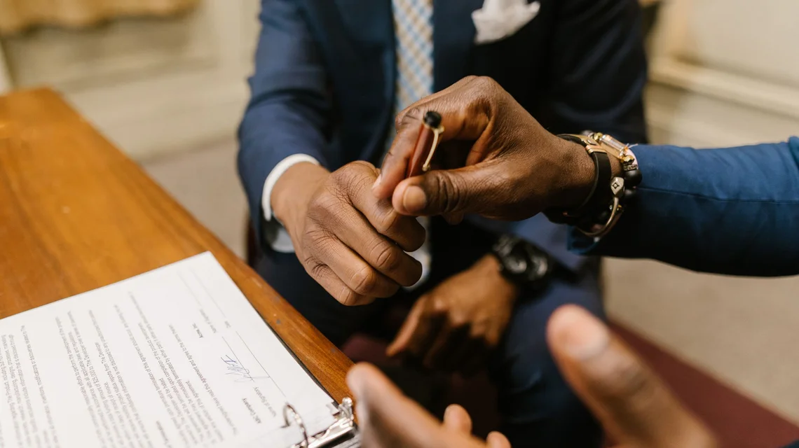 Signing a business acquisition agreement in an office