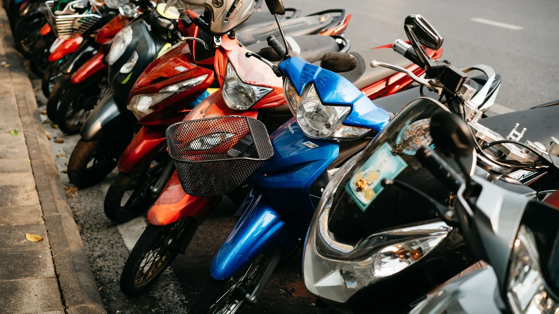 Row of motorbikes parked outside a depot, the everyday fleet a Dubai delivery partner runs