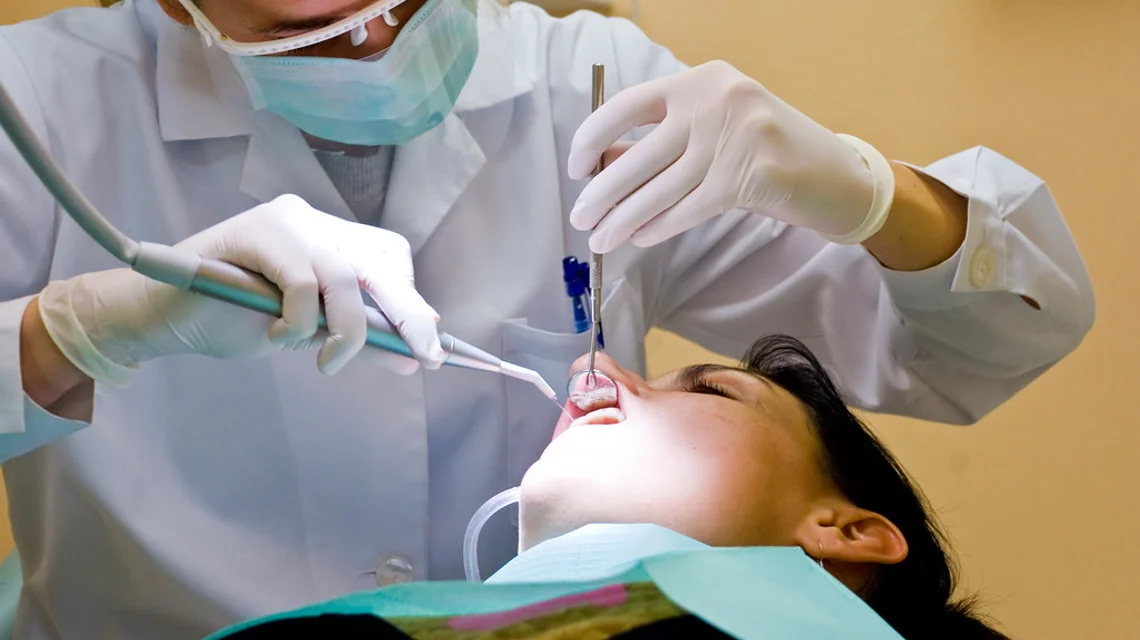 Dentist treating a patient in a modern dental surgery