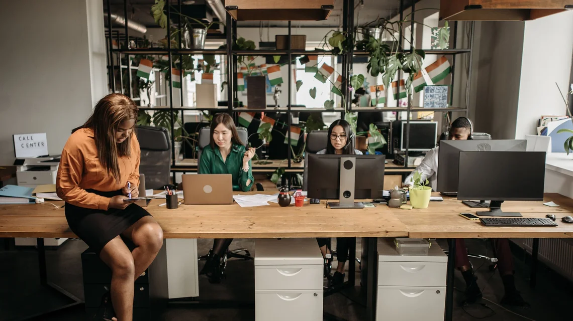 An open-plan office with staff at work, of the kind used to evidence operating substance