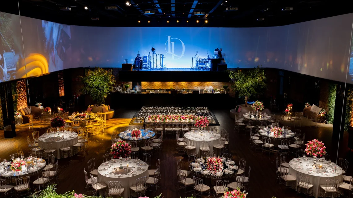 A produced gala dinner build with stage, LED wall and floral centrepieces in Dubai