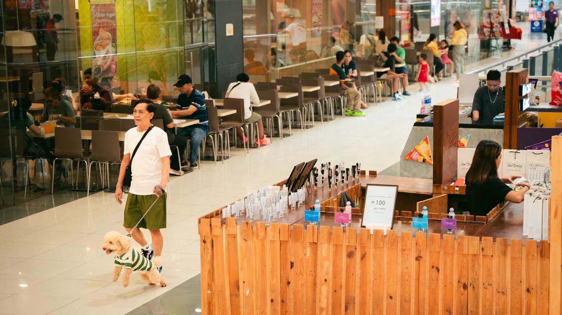 Compact food and beverage kiosk with a service counter and display cabinet inside a Dubai shopping mall concourse