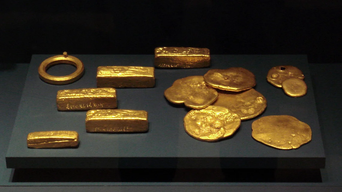 Refined gold bars and coins on display