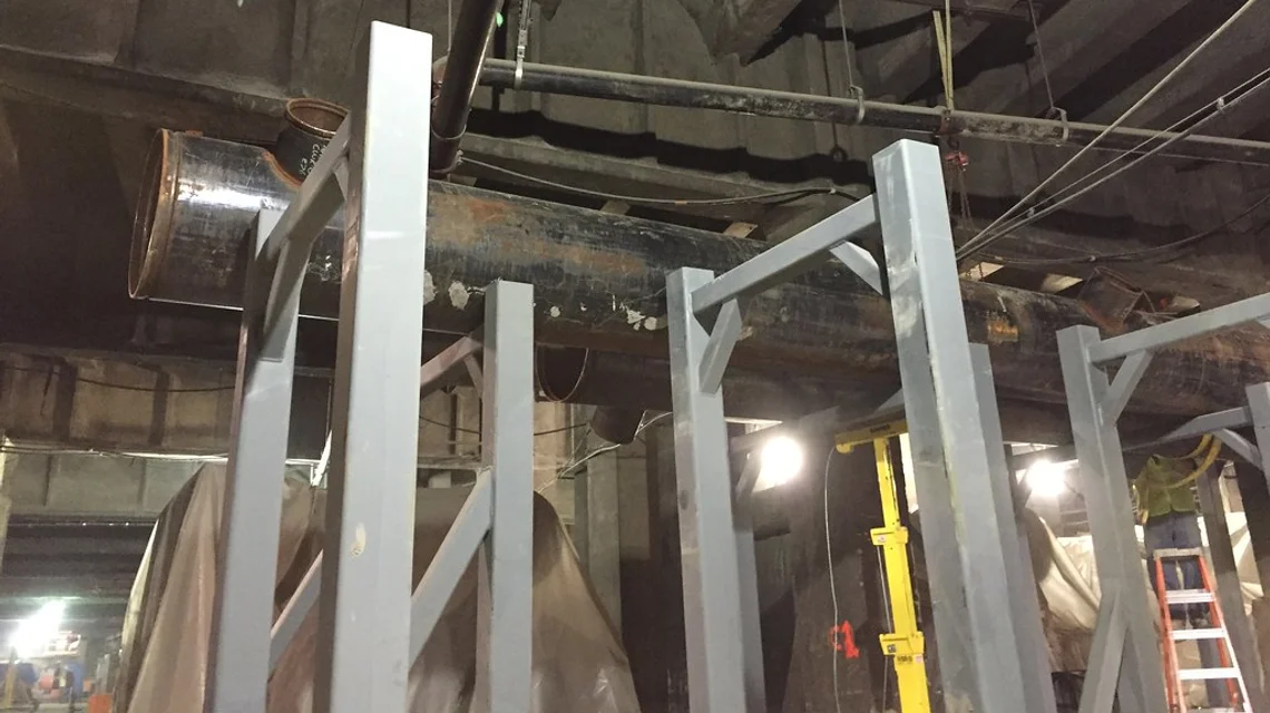 Large industrial HVAC chiller and ductwork in a plant room