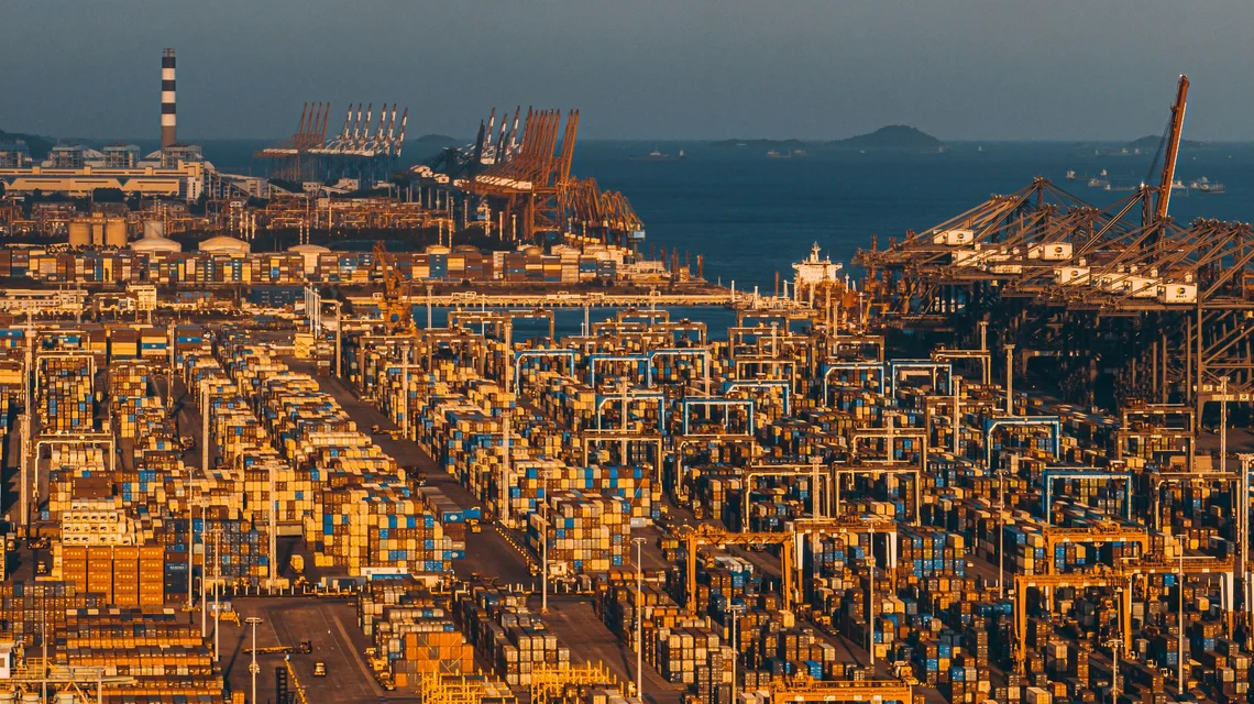 A large container terminal at a Chinese port at golden hour