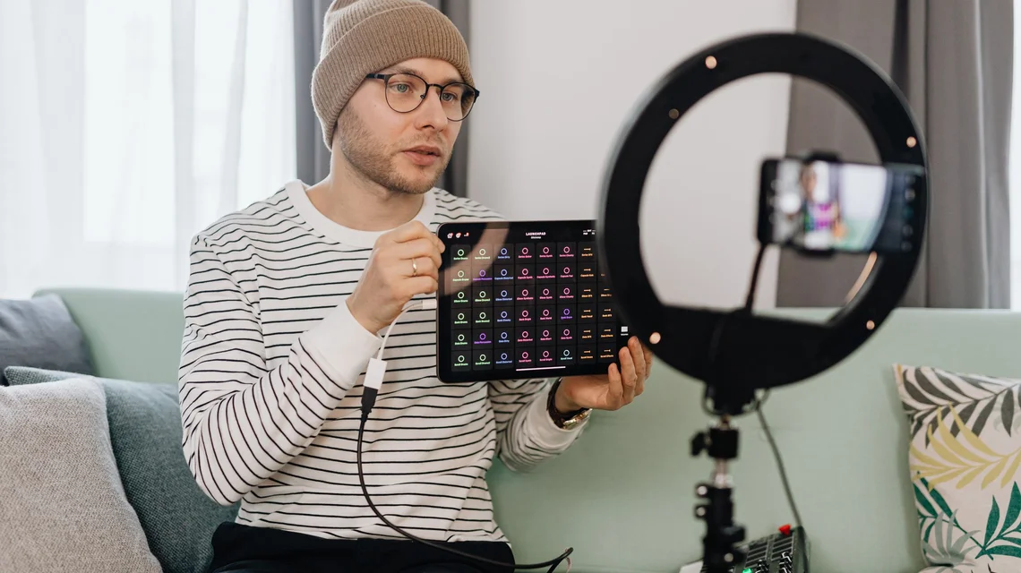 Creator filming a product video on a phone with a ring light