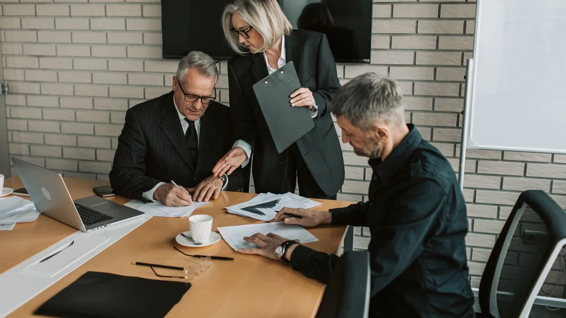 Insurance professionals reviewing policy paperwork in an office