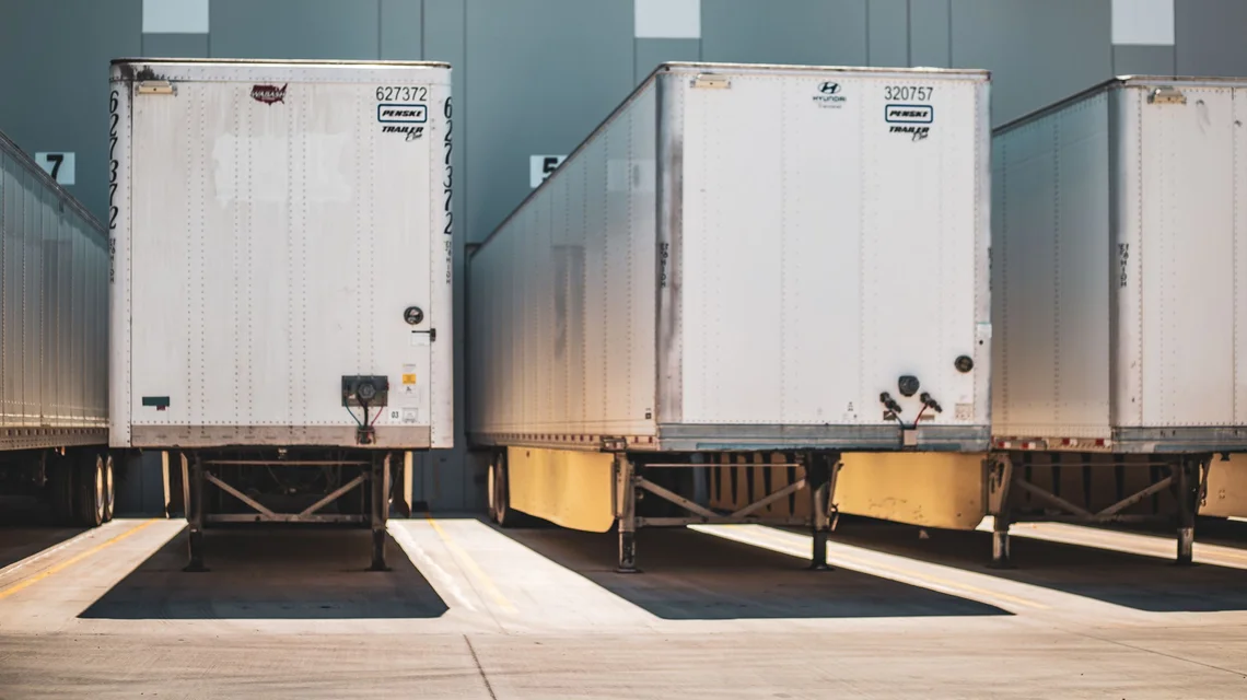 Racked pallets and a reach truck inside a free zone warehouse unit