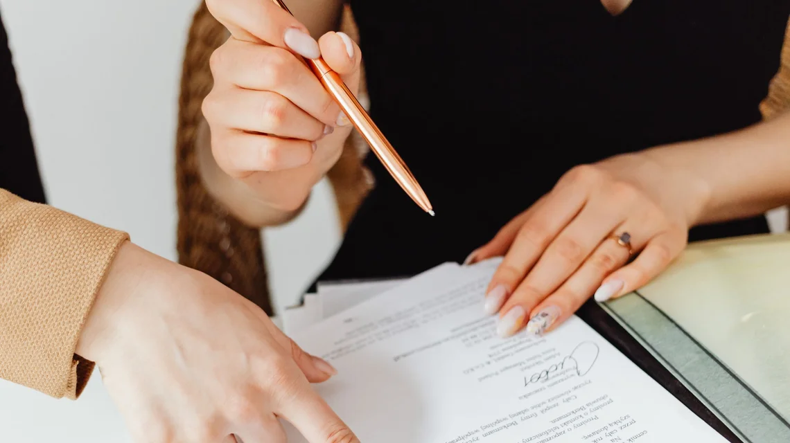 Advisers reviewing final liquidation paperwork at a desk