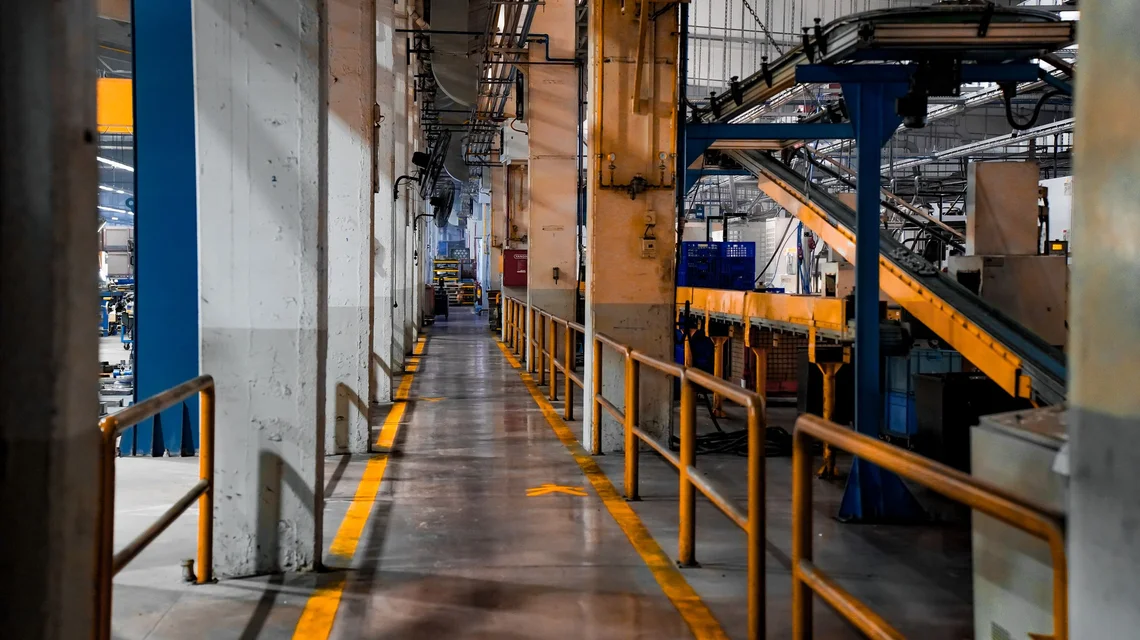 Interior of a modern factory with conveyor systems and production machinery