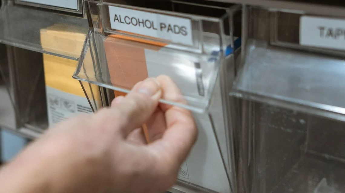Medical supplies organised on labelled shelves in a healthcare storeroom