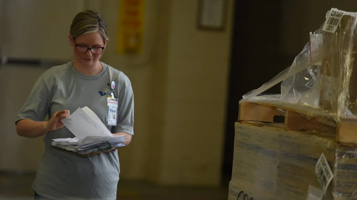 Pharmacist checking medicine inventory in a distribution warehouse