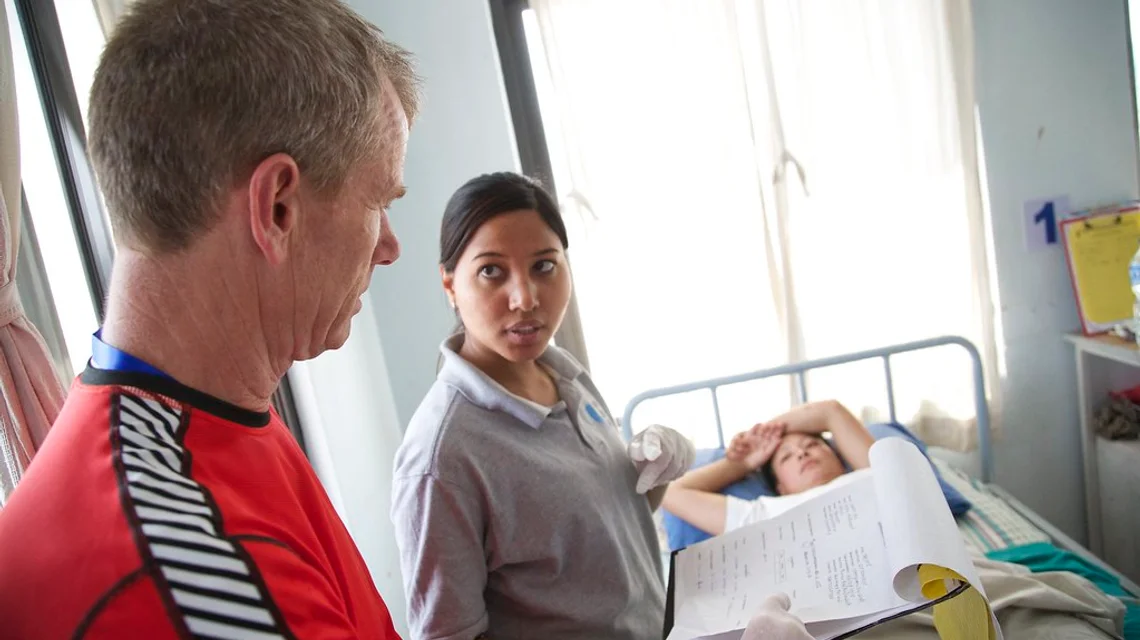 Physiotherapist treating a patient on a treatment table in a clinic