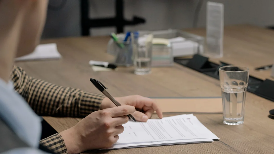 Officer processing documents and paperwork at a service desk
