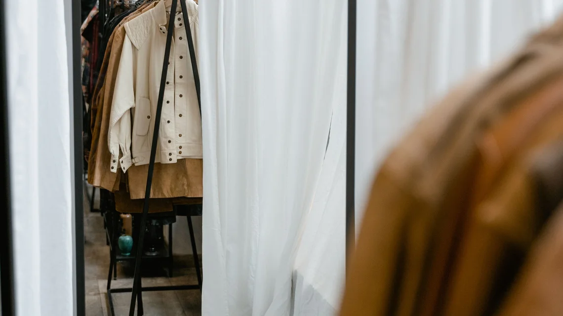 Shop assistant arranging stock inside a fitted-out retail unit in a Dubai shopping mall
