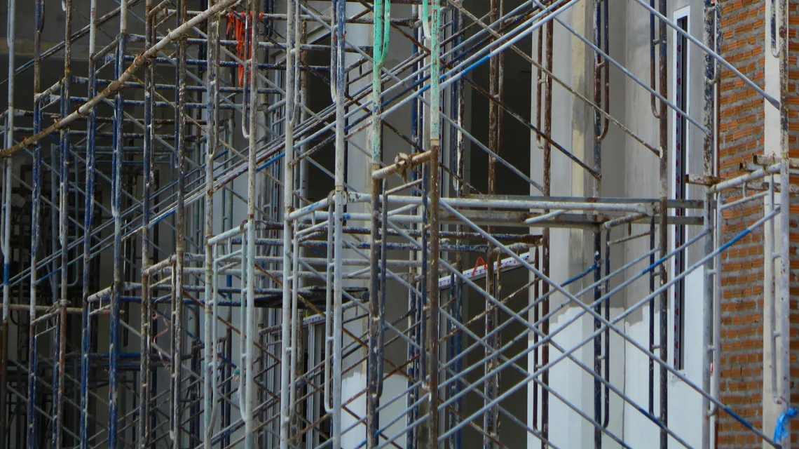 Scaffolding tube, fittings and boards stacked and racked in an industrial storage yard in Dubai