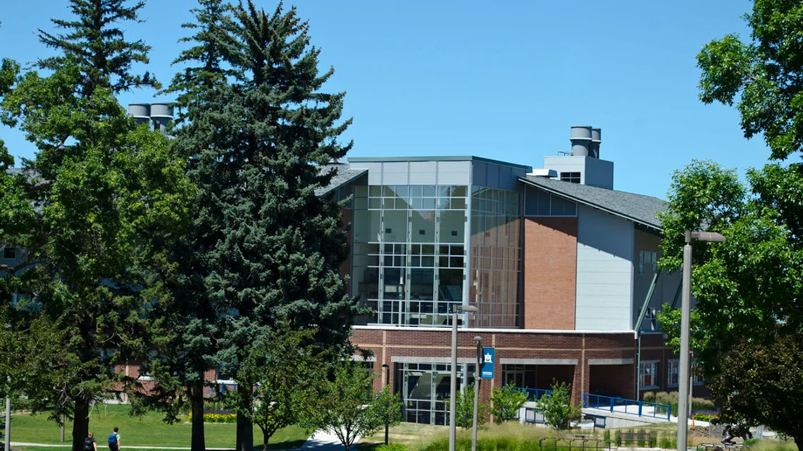 Modern private school building exterior with students outside