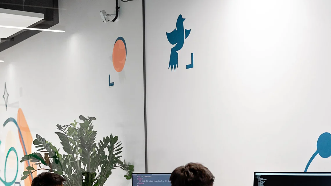 Software engineers reviewing code on screens in a Dubai free zone office