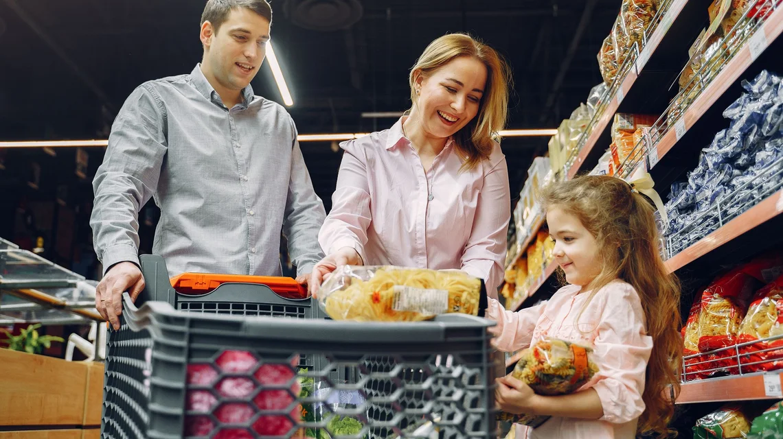 Shoppers choosing groceries in a supermarket aisle