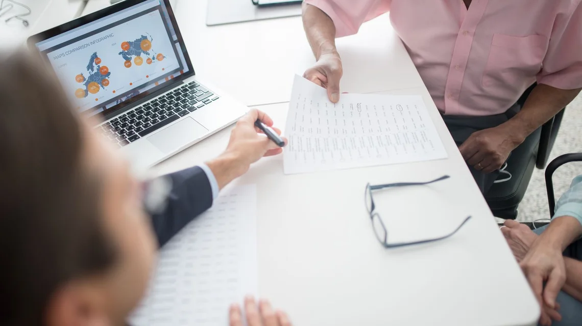 Tax adviser reviewing financial statements and returns with a client