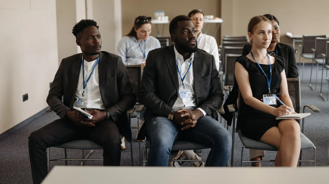 Professionals attending a corporate training session in a Dubai training room