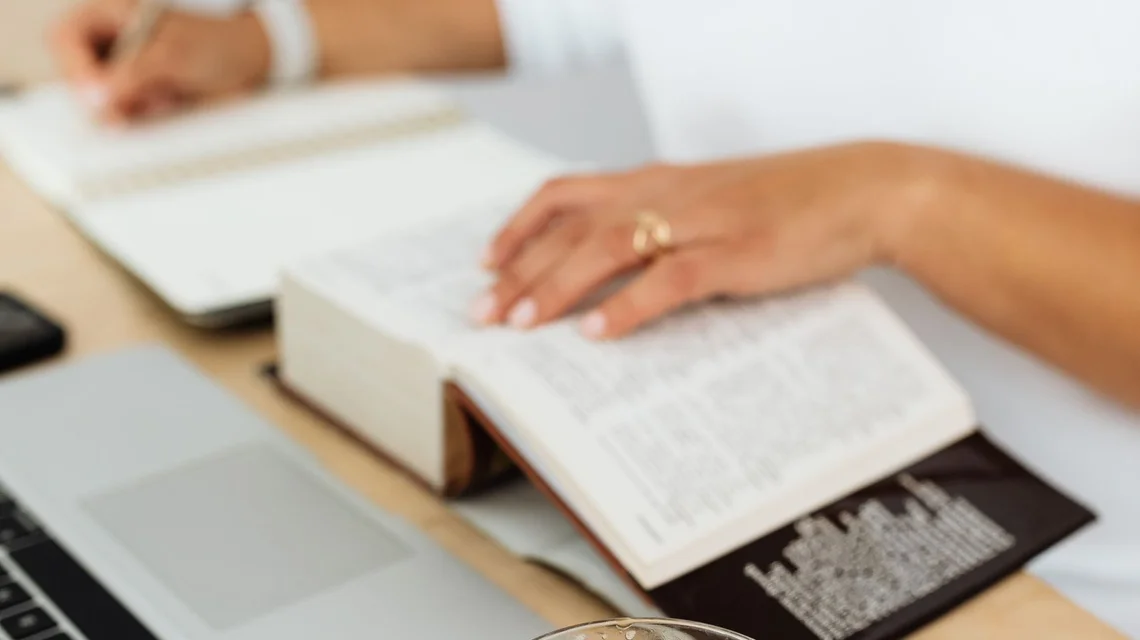 Translator working on documents across languages at a laptop