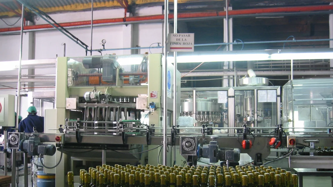 Bottled water moving along an automated filling and capping production line