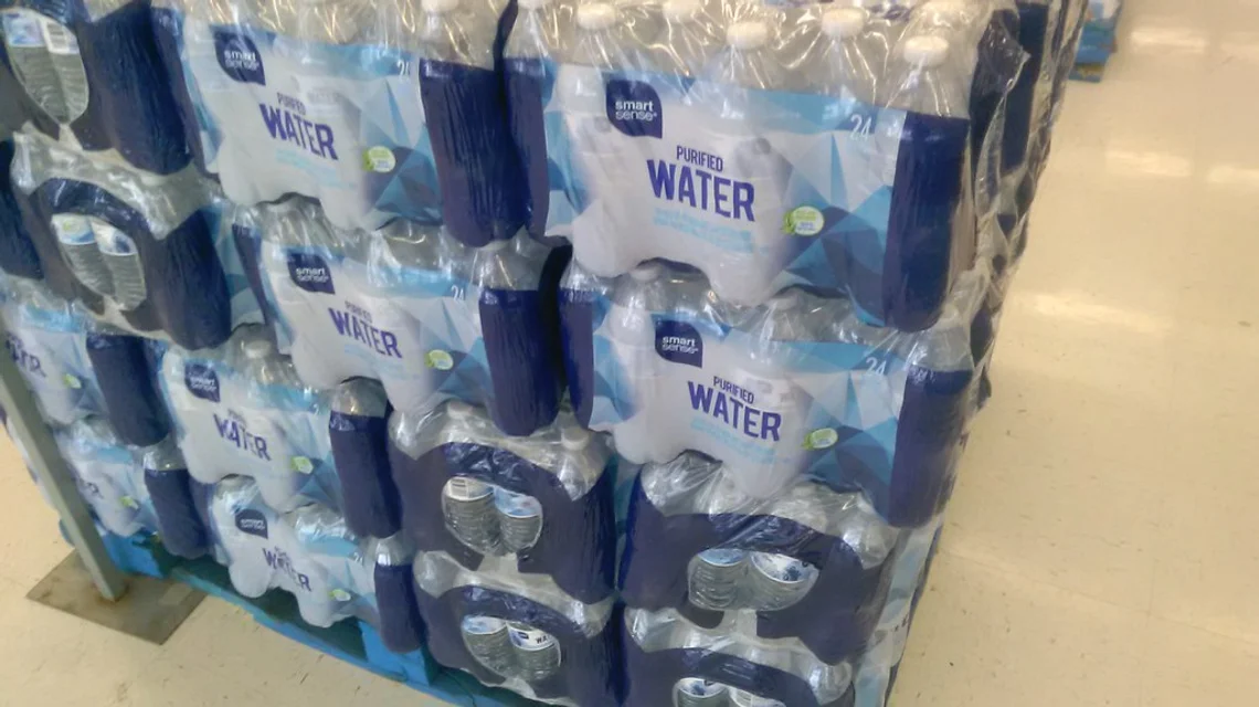 Rows of sealed plastic water bottles packaged for distribution
